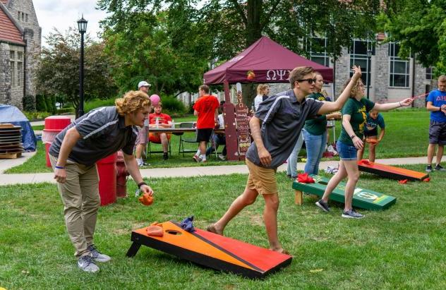 students playing corn hole